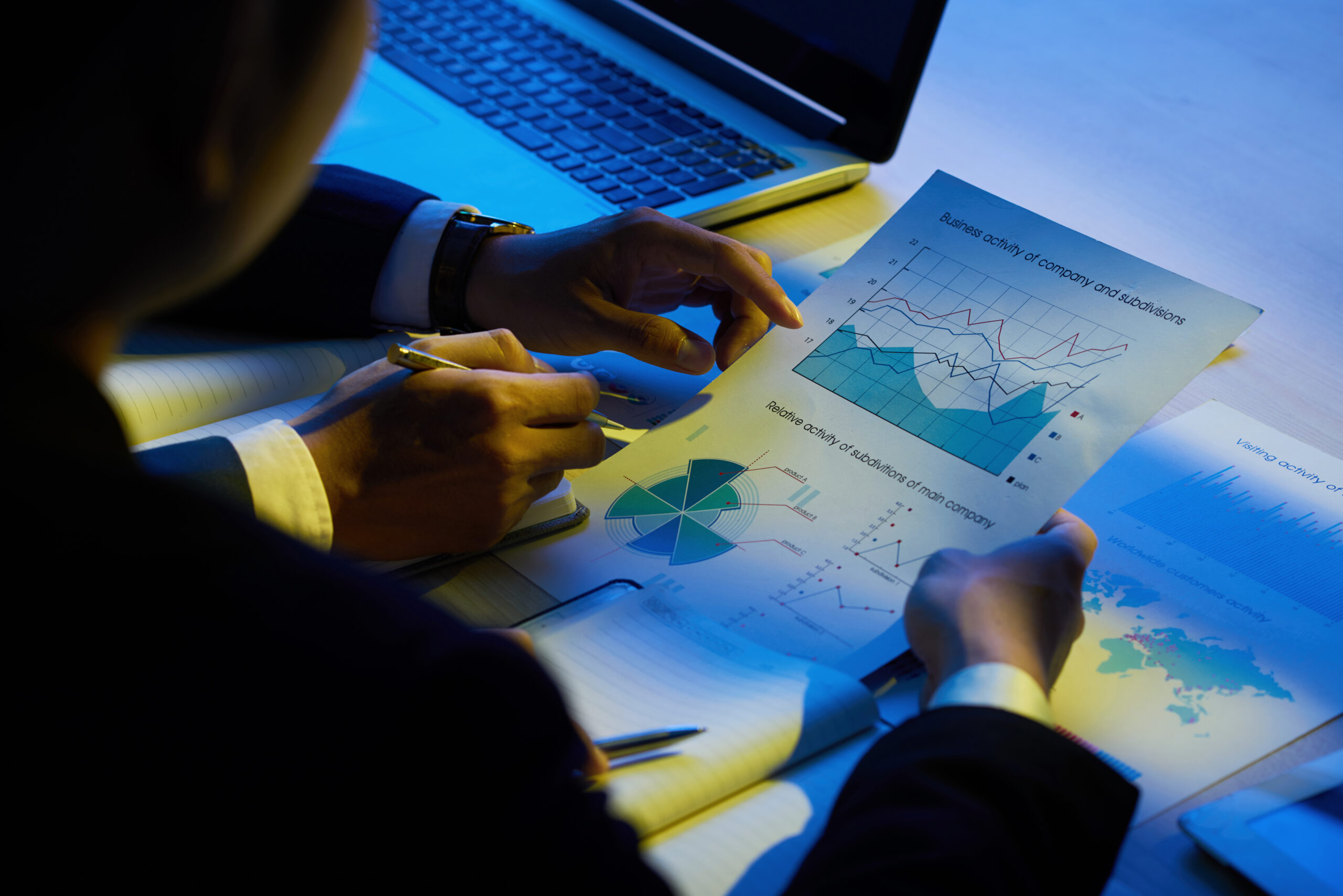 Hands of business executives analyzing company activity